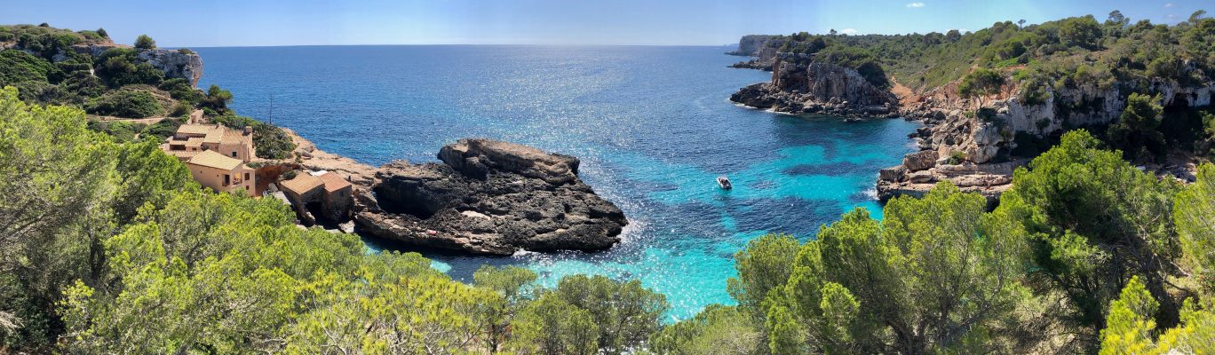 Photo of rugged landscape and shimmering sea in sunny Mallorca